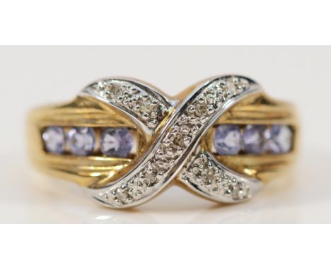 A 9ct gold diamond and tanzanite cross over ring, P, 3.6g