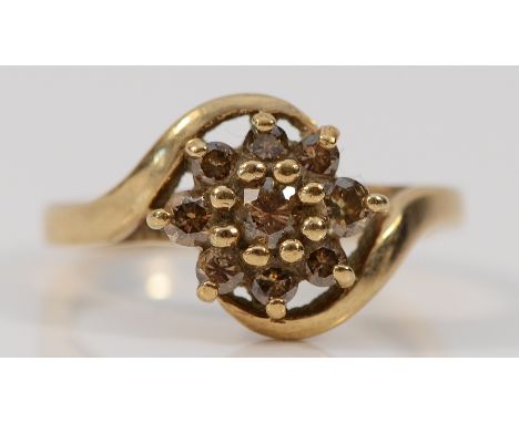 A 9ct gold diamond floral cluster cross over ring, K, 2.7g