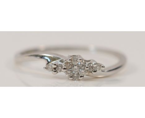 A 9ct white gold diamond cluster ring, stated 0.10ct, K 1/2, 1g