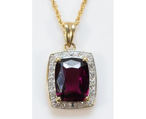 A 9ct gold garnet and diamond pendant on a chain, 9mm x 6mm garnet, 2.4g