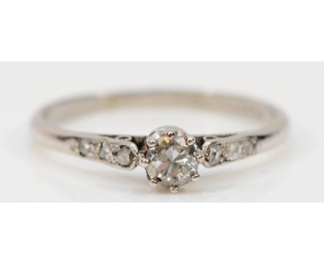 A platinum brilliant cut diamond solitaire ring with diamond set shoulders, P, 2.7g