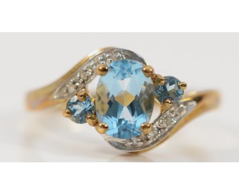 A 9ct gold diamond and blue gemstone cross over ring, Q, 2.4g
