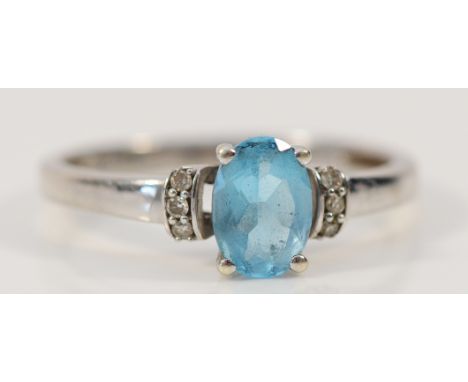 A 9ct white gold blue topaz solitaire ring with diamond set shoulders, M, 1.9g