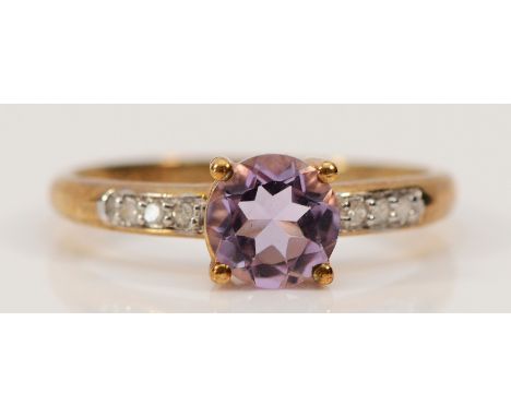 A 9ct gold amethyst solitaire ring with diamond set shoulders, L, 1.5g
