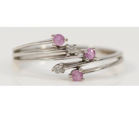 A 9ct white gold diamond and pink gemstone cross over ring, P, 1.5g