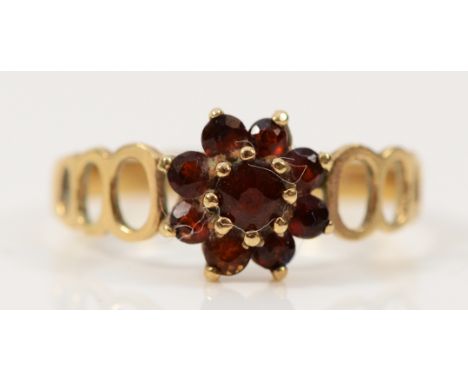 A 9ct gold garnet floral cluster ring with open work shoulders, S 1/2, 2.3g