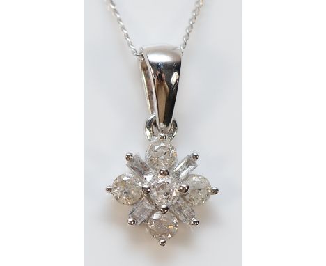 A 9ct white gold diamond cluster pendant on a chain, 1g
