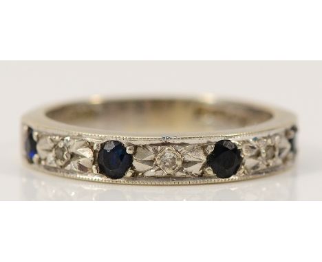 A 9ct white gold diamond and sapphire half eternity ring, London 1977, M, 3.1g