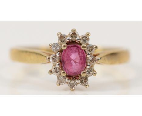 A 9ct gold brilliant cut diamond and pink sapphire cluster ring, O, 2.3g