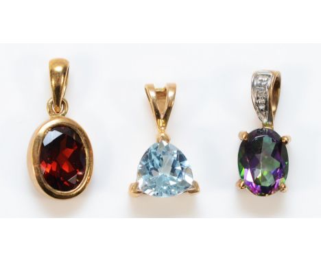 A 9ct gold mystic topaz pendant, 8mm x 6mm topaz, a 9ct gold garnet pendant, 9mm x 6mm garnet, with a 9ct gold blue gemstone 