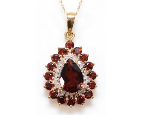 A 9ct gold garnet and diamond pendant on a chain, 10mm x 7mm central garnet, 20mm pendant, 3.2g