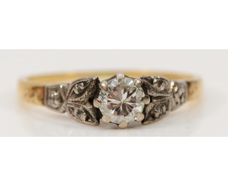 An 18ct gold and platinum brilliant cut diamond solitaire ring with rose cut diamond set shoulders, approx 0.20ct central dia