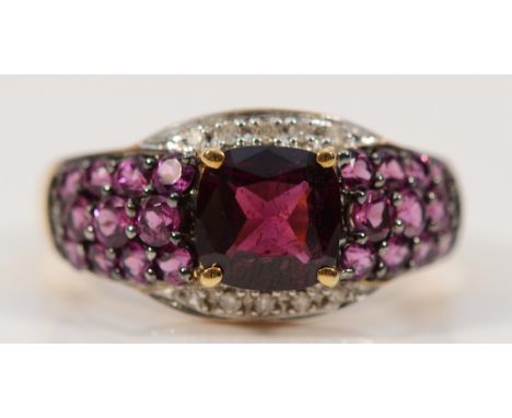 A 9ct gold diamond and garnet dress ring, Q, 3.2g
