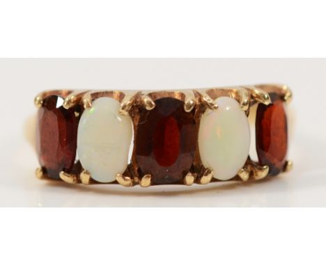 A 9ct gold garnet and opal five stone ring, Birmingham 1975, P, 2.6g