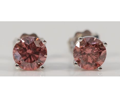 A pair of 9ct white gold pink diamond earrings with scroll backs, approx 0.33ct per earring, 0.7g