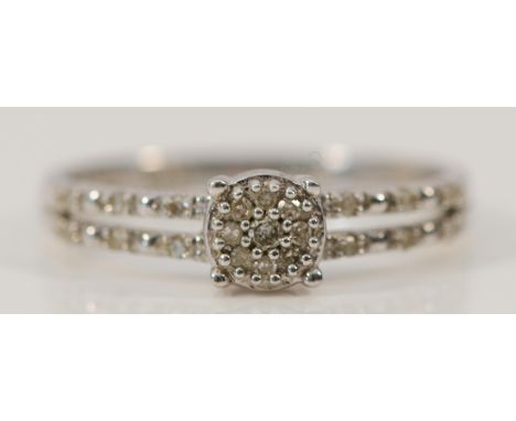 A 9ct white gold diamond cluster ring with diamond set shoulders, L, 1.8g