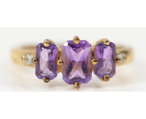 A 9ct gold amethyst three stone ring with diamond set shoulders, H, 1.6g
