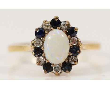 A 9ct gold opal, brilliant cut diamond and sapphire cluster ring, London 1981, O, 1.8g