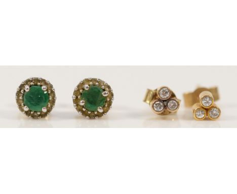 A pair of 9ct gold emerald and diamond cluster earrings with scroll backs, together with a pair of 9ct gold diamond earrings 