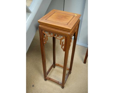A 20th Century Chinese hardwood plant stand, the square top above channelled legs and scroll spandrels, raised on spade feet 