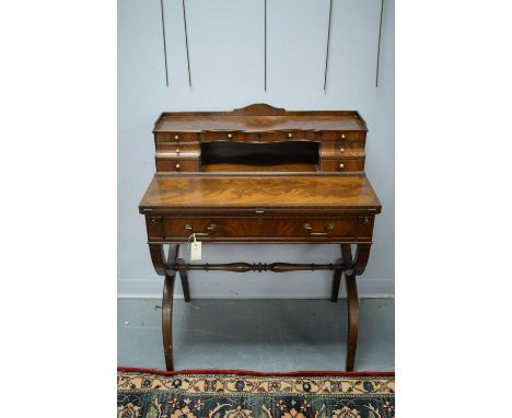 A 20th Century mahogany lady's writing desk, with raised superstructure comprising drawers and pigeon holes, above a hinged t