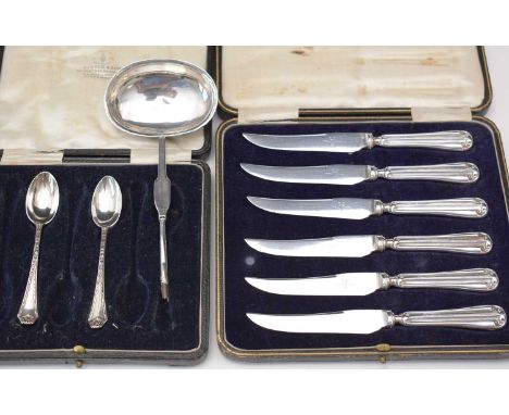 A set of six tea knives with silver filled handles, in fitted case; two silver teaspoons in fitted case; and a white metal to