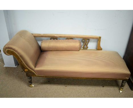 An Edwardian-style mahogany framed chaise longue, with scroll-over arm and pierced back above a padded seat, raised on ring t