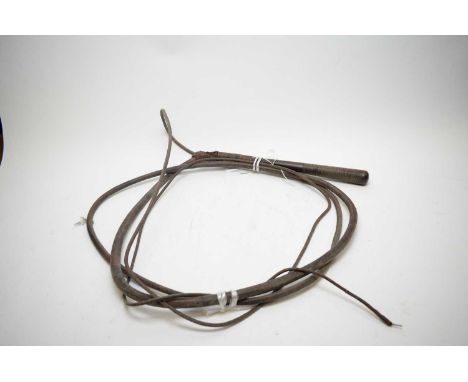 A leather tapering bull whip with hardwood turned handle.