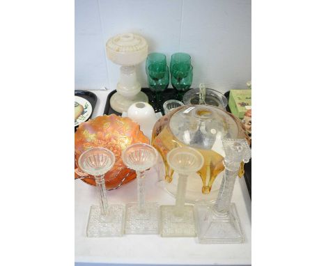 A quantity of glassware, including: four pressed glass candlesticks; three Carnival glass bowls; a set of four green glass go