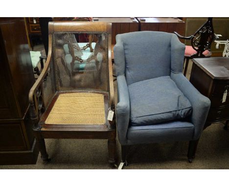 A late Victorian mahogany framed bergere armchair, the rectangular canework back and downswept arms with interlocking support