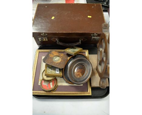 A Vintage leather case, A ship's wheel ornament, Miniature portrait photographs, and other frames, etc.