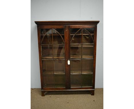 A 19th Century mahogany bookcase, possibly converted from a bureau bookcase, the projecting cornice above a pair of astragal 