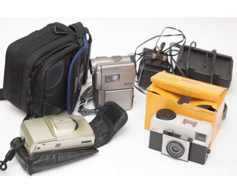 A Canon MV3 MC digital video camcorder, carry case with adaptor, charger; together with a boxed Kodak 125 Instamatic; and an 