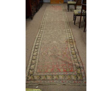 A Caucasian runner, early 20th Century, with small flowerhead motifs and boteh design to border, 566 x 115cms.