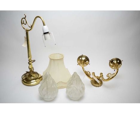 A reproduction lacquered brass double branch wall light with frosted glass flame shades; a lacquered brass table lamp and sha