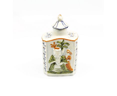 A Prattware tea caddy and cover with ‘macaroni ‘ figures moulded to the body. Decorated in green, blue and ochre.  Circa 1800