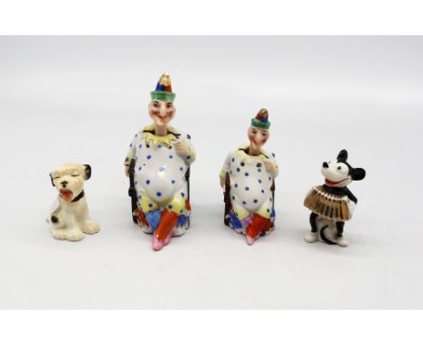 Two porcelain figurines of Mr Punch, both with nodding heads, with mixed speckled clothing and hats, both unmarked, largest a