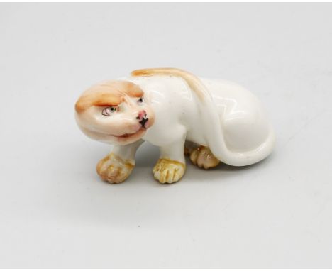 A Royal Worcester netsuke modelled as a Cheetah, early 20th century, painted details to white ground, green Worcester mark un