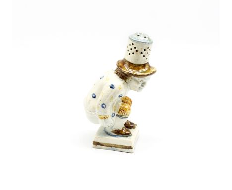 A Prattware pepper pot in the guise of Roger Giles.  Circa 1800-1820. Size. 11.5cm high  Condition. Stress fracture to unders