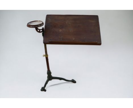An adjustable reading stand on cast iron tripod feet