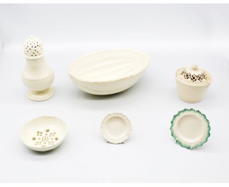 A small collection of creamware to include a melon tureen base, sugar caster, drainer, two miniature plates and a basket weav