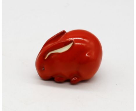 A Royal Worcester netsuke modelled as a Rabbit, orange colourway, circa 1913, with green stamp underneath, approx. 3.5cm high