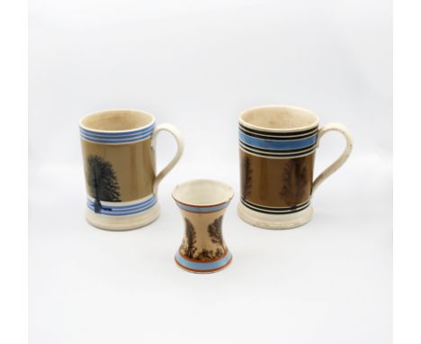 A Mocha ware Quart sized mug, mid brown ground with feathered sepia trees, blue band and six black bands, along with another 