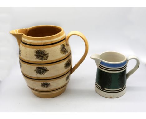 A large mocha ware pitcher, cream ground with ochre and black bands with black trees. C 1810, approx. 21cm high. (broken thro