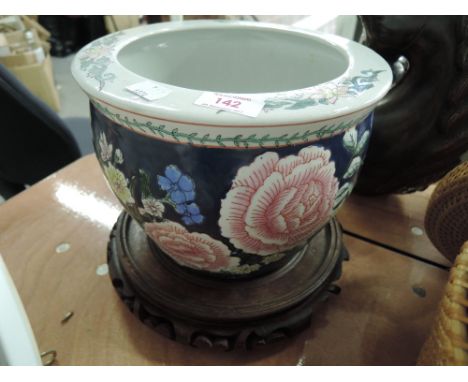 An oriental ceramic planter pot with floral pattern