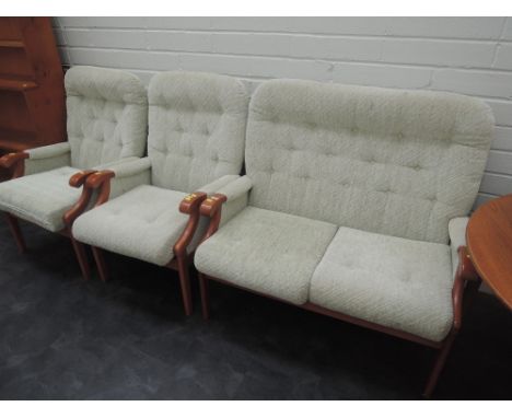 A vintage three piece lounge suite having wood frame and green upholstery