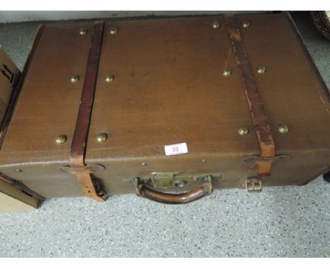 A vintage suit case or travel trunk Leather bound with brass lock and clasp