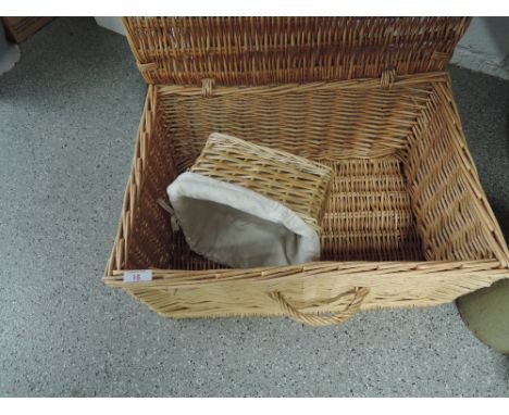 A wicker woven picnic hamper with similar