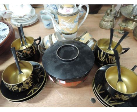 A selection of vintage oriental style ceramics and papier mache cups and saucers