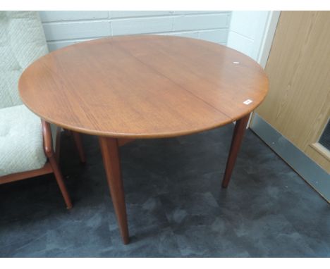 A vintage teak circular extending dining table